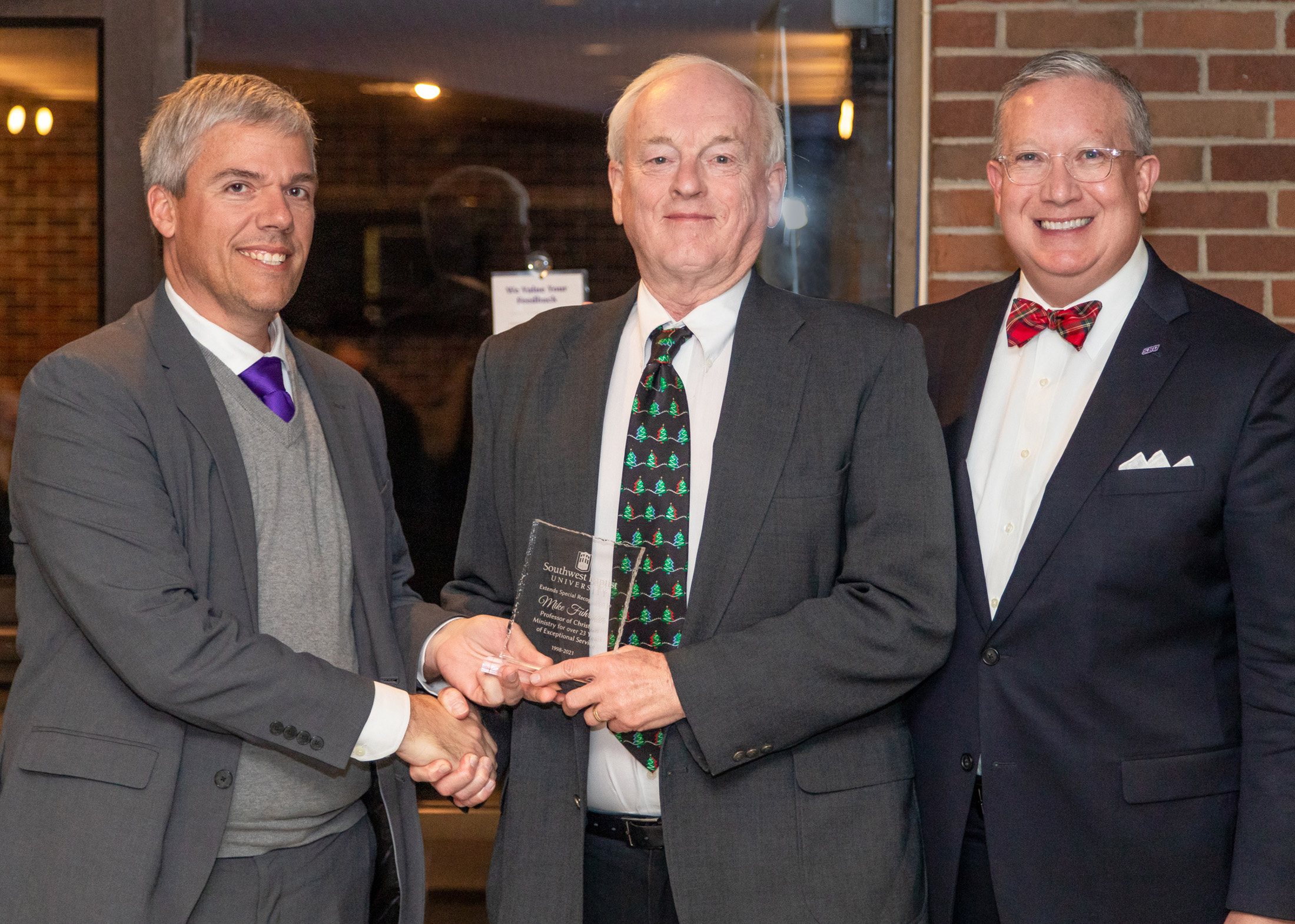 Dr. Mike Fuhrman received a retiree recognition from Provost Lee Skinkle (left) and President Rick Melson