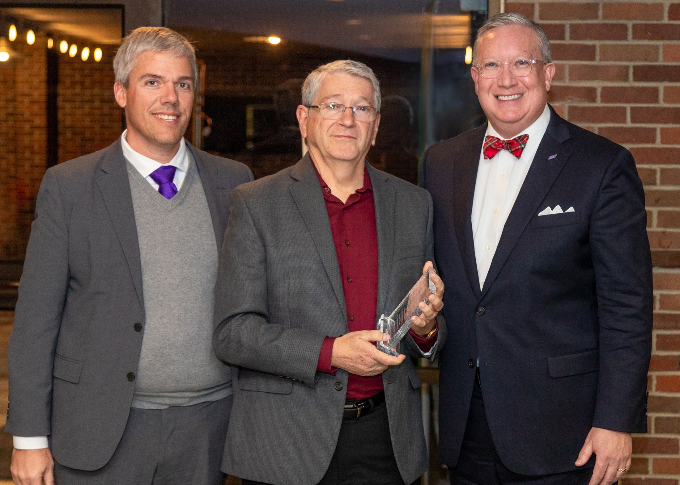 Dr. Bing Bayer received a retiree recognition from Provost Lee Skinkle (left) and President Rick Melson