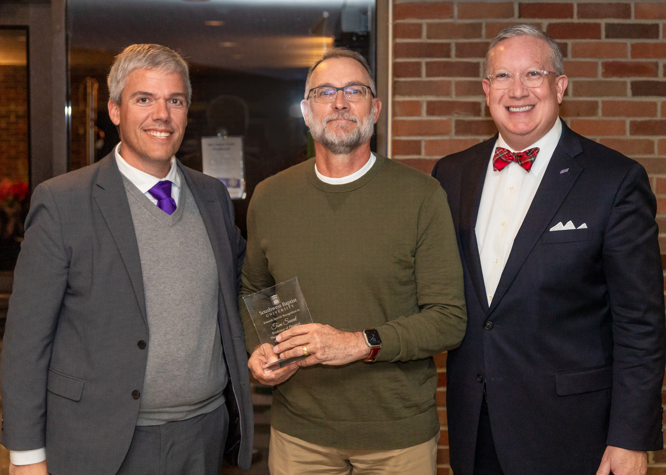 Dr. Tom Sneed received a retiree recognition from Provost Lee Skinkle (left) and President Rick Melson