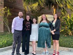 Mr. Corlee and four female students on forensics team stand outside