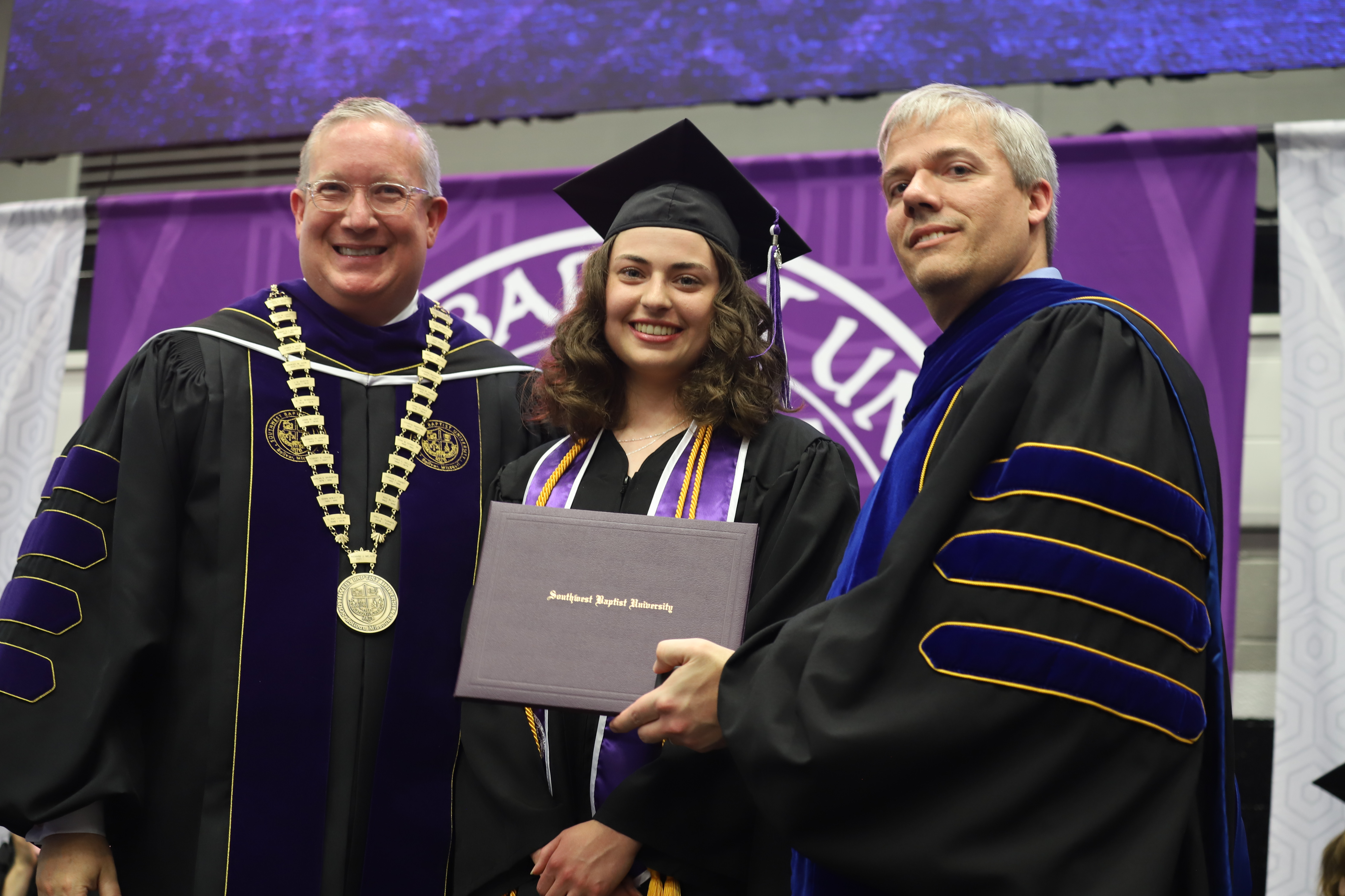 President Rick Melson, Corynn Knight, and Provost Lee Skinkle as Corynn is presented with award