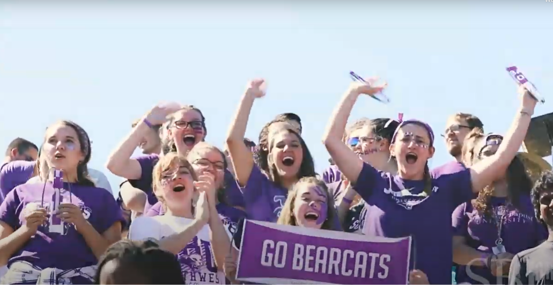 students cheering at football game