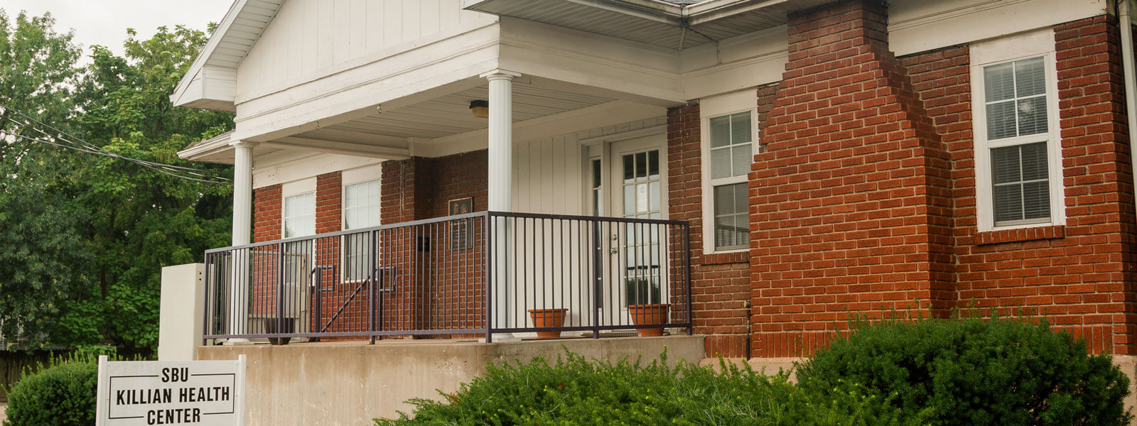 campus nurse and office assistant; front entrance view of Killian Health Center