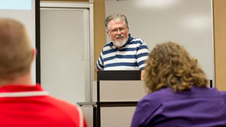 students listen to professor lecture