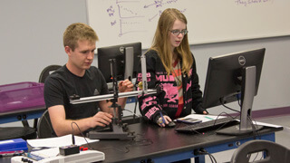 two students working on physics project