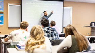 student reading Bible in class