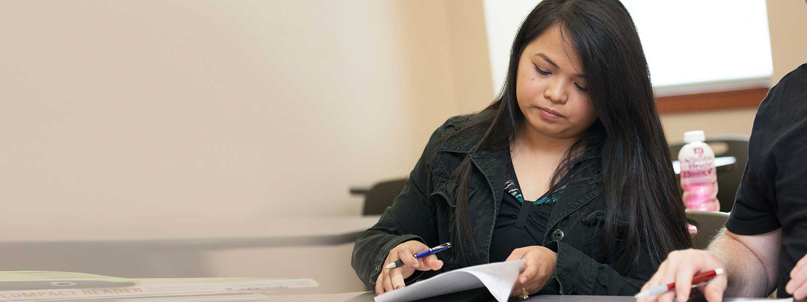 female student looks over notes