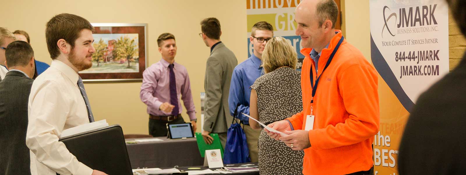 students interact with professionals at career fair