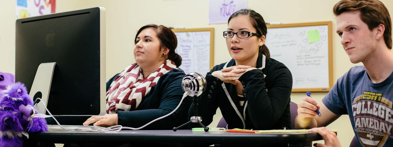 students recording podcast using Mac computer