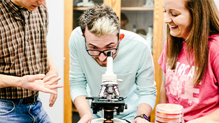 students work on physics experiment