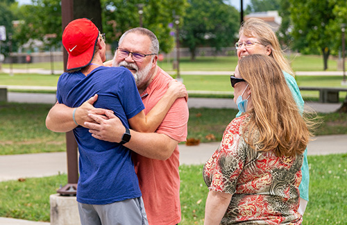 family hugging and visity Bolivar campus