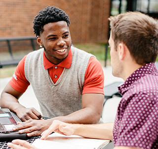 students talking on SBU campus